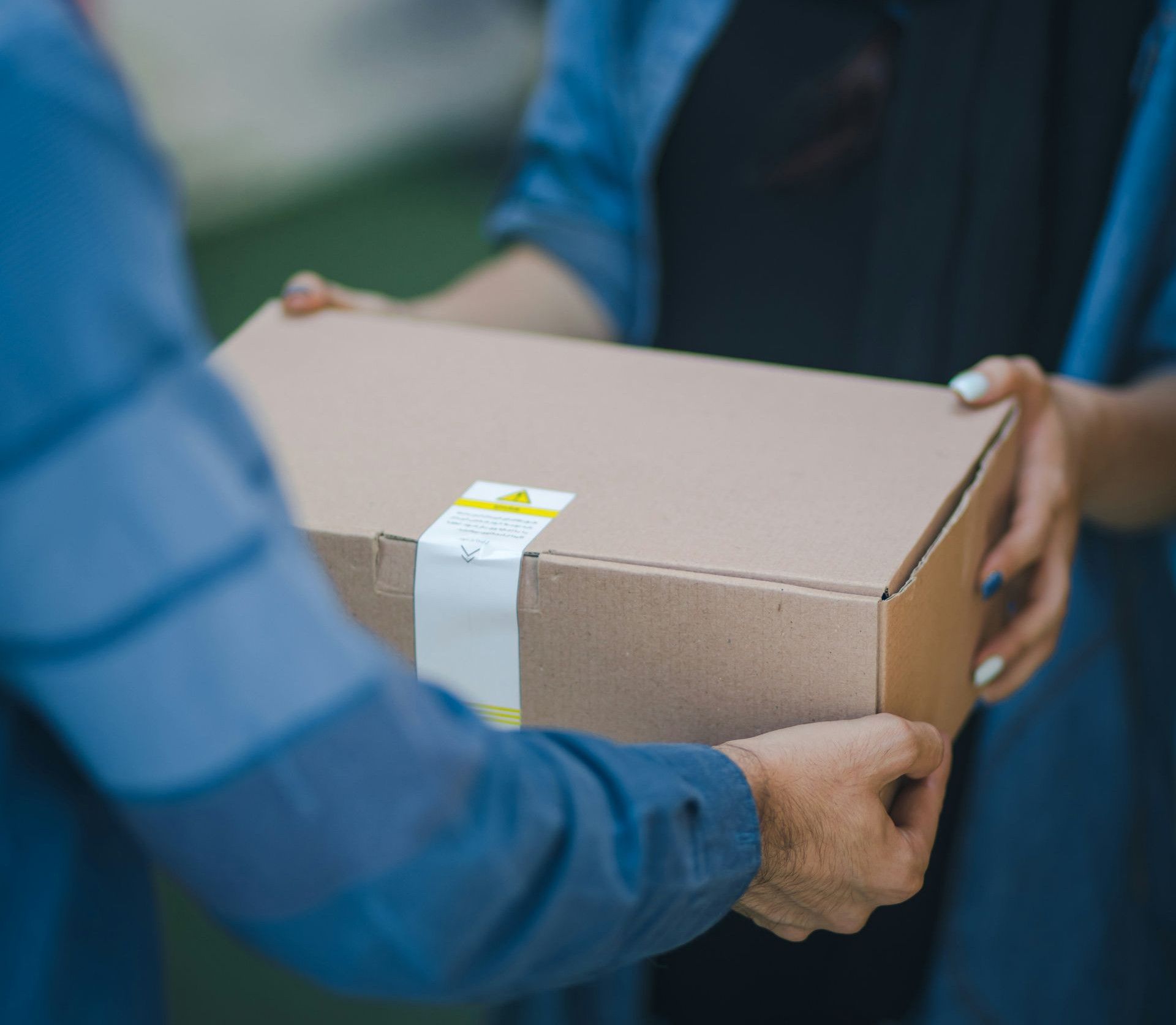 person giving brown box